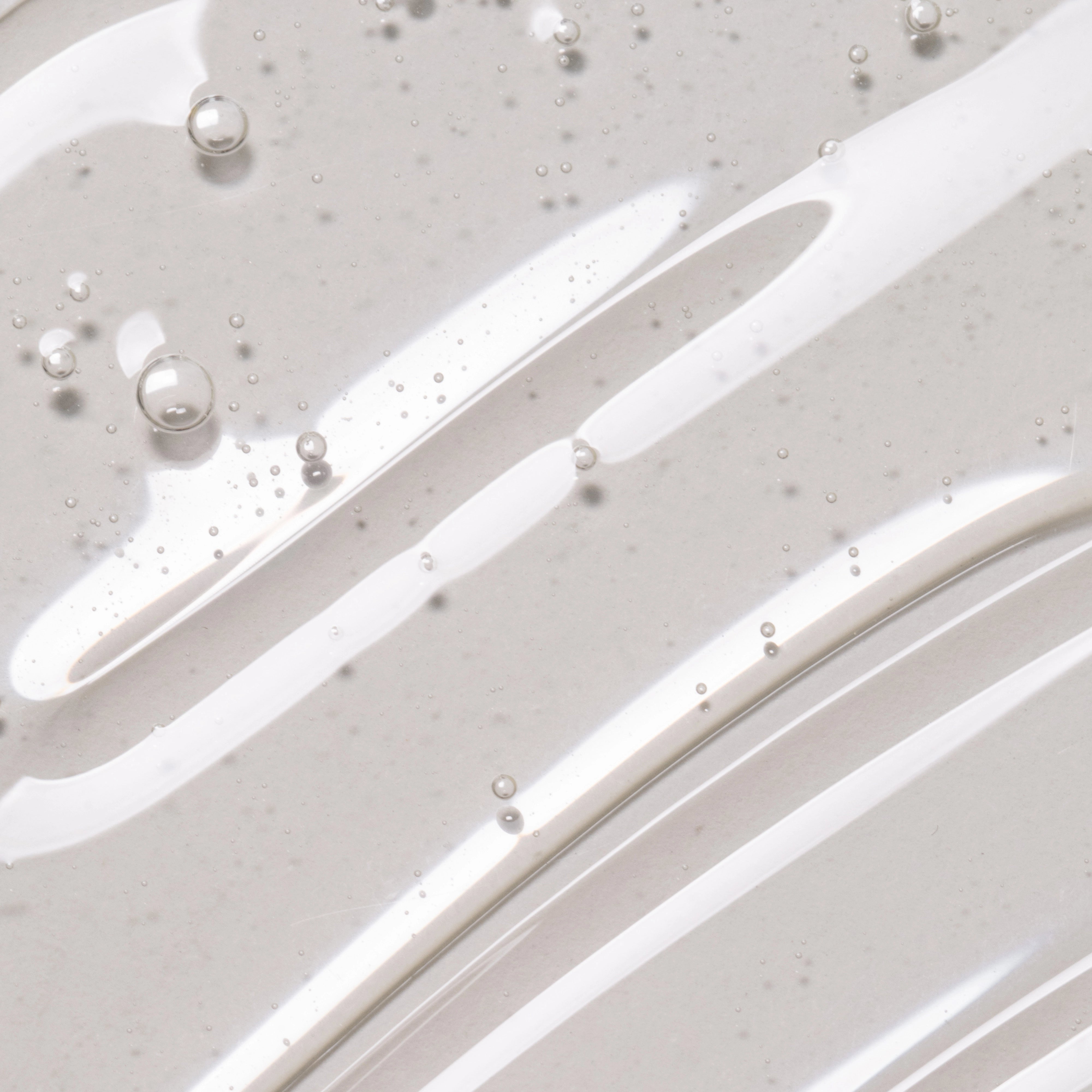 Close-up of Feel Confident Thickening Scalp Serum texture — lightweight leave-in formula for stronger hair